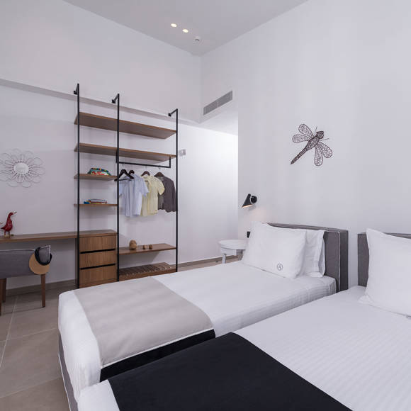 Bright two bedroom villa with twin beds, modern decor and open wardrobe at Avdou Collection Crete