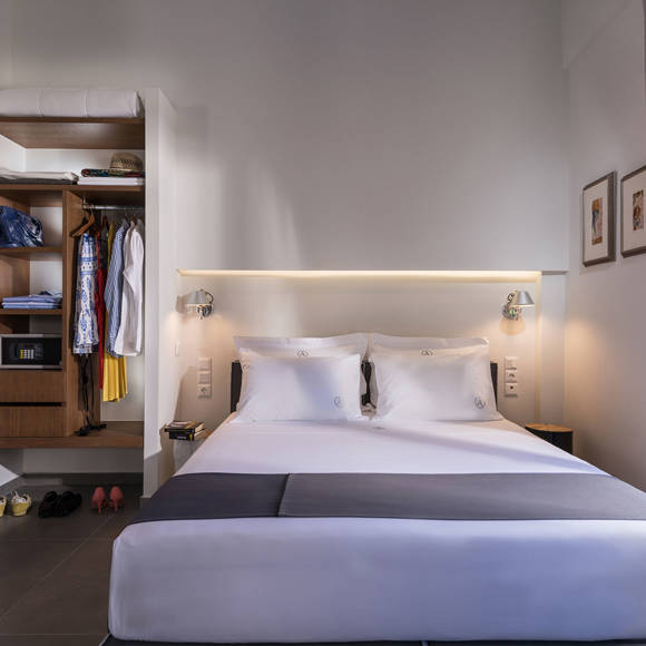 Open plan suite with double bed, open wardrobe and modern design at Avdou Collection Suite