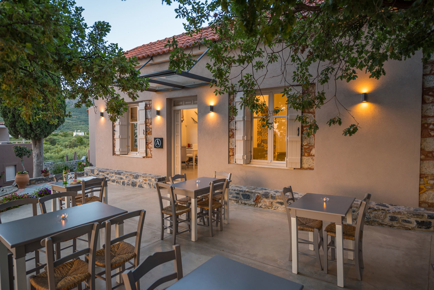 Cozy outdoor restaurant cafe with warm lighting and traditional seating at Avdou Collection Crete