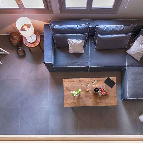 Loft view of the living room with sectional sofa, coffee table and minimalist decor at Avdou Collection Crete